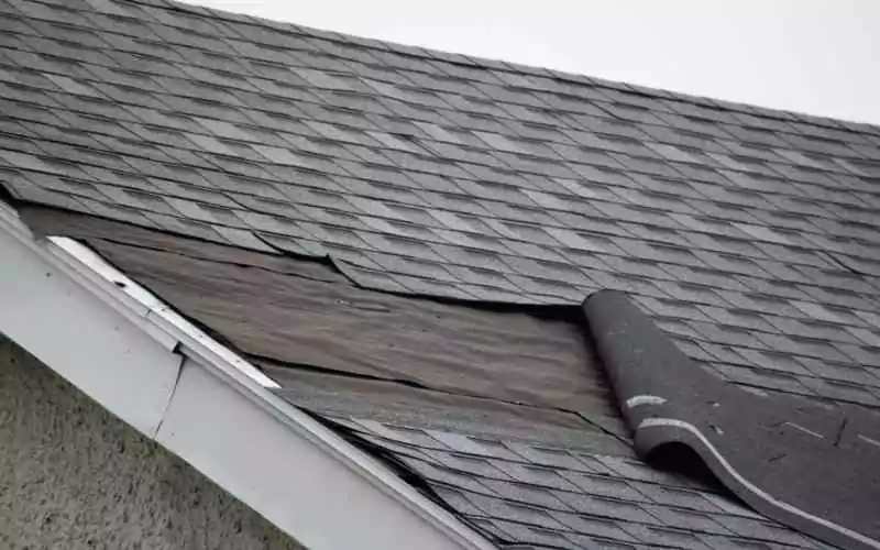wind-damage-to-roof-peeled-back-shingles